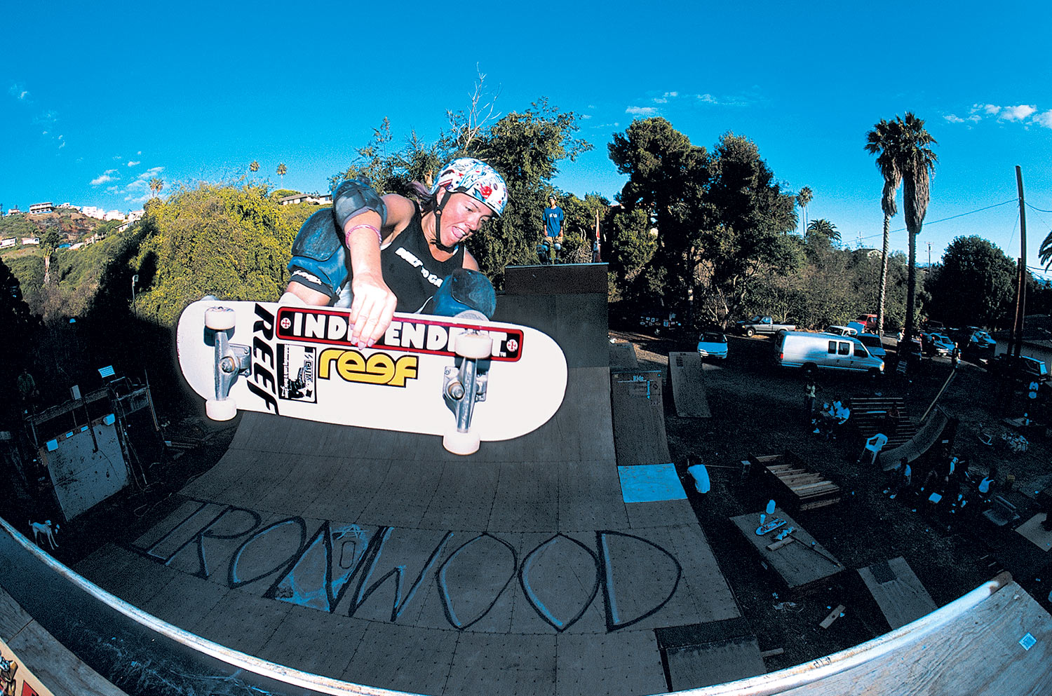 Skater Girl Grinding on a Ledge in a Outdoor Skatepark in Summer