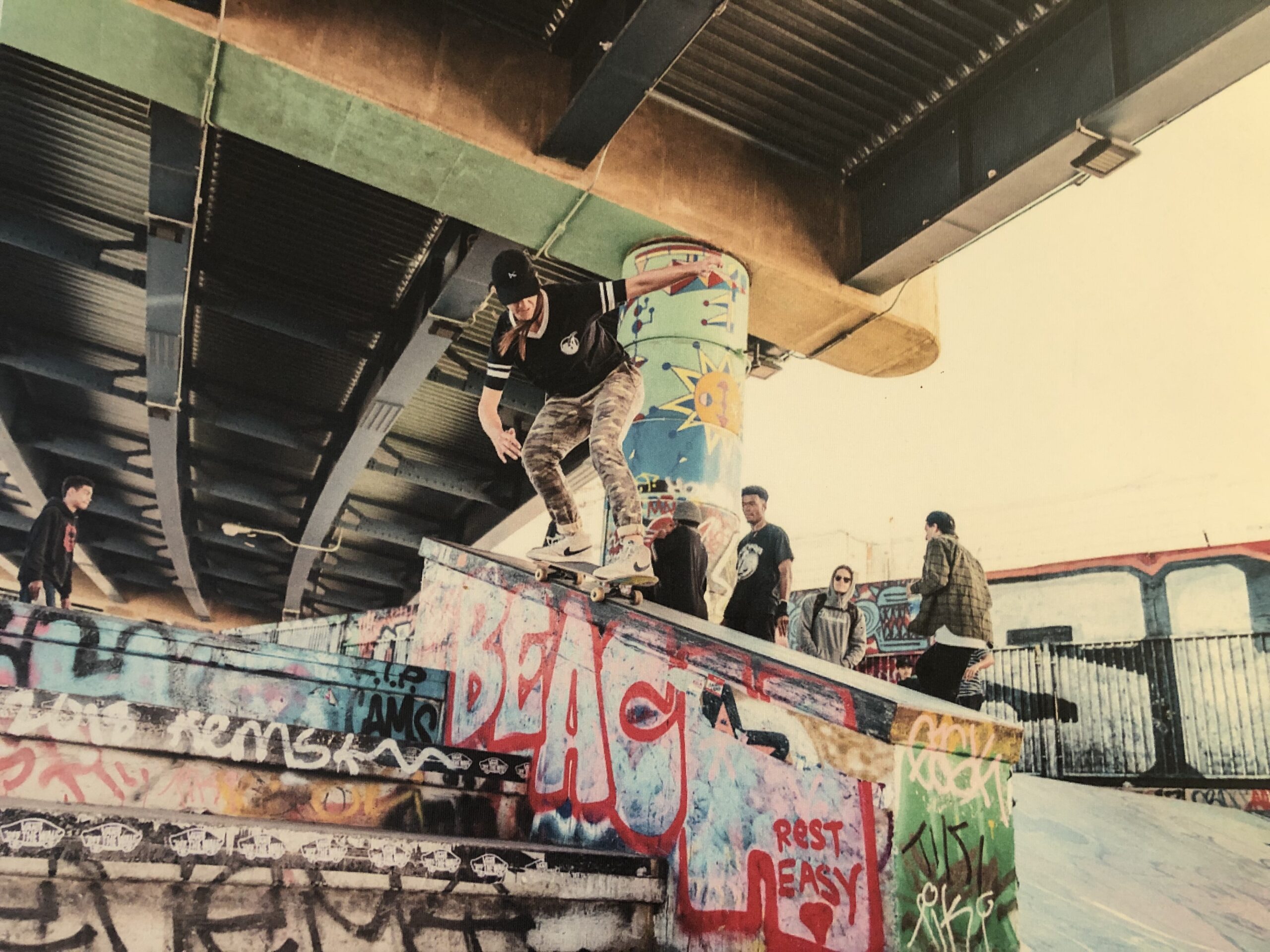 Skater Girl Grinding on a Ledge in a Skatepark. Feet of Aggressive